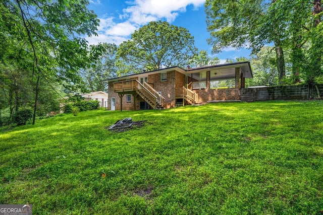 6467 Joanna St, Lithia Springs, GA 30122 - back of house with stairway, brick siding, and a yard