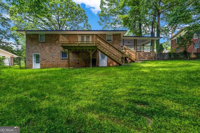 6467 Joanna St, Lithia Springs, GA 30122 - back of property with stairs, brick siding, and a wooden deck