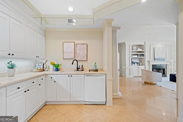 kitchen featuring sink, dishwasher, white cabinetry, ornamental molding, and ornate columns