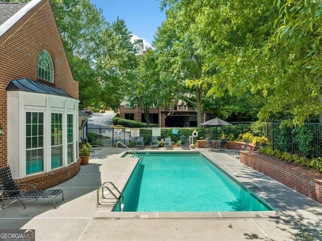 view of swimming pool featuring a patio area