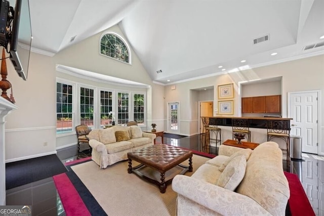 living room with crown molding and high vaulted ceiling