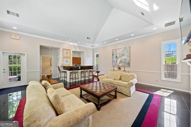 tiled living room with crown molding and vaulted ceiling