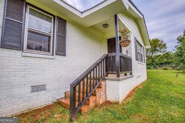 doorway to property featuring a yard