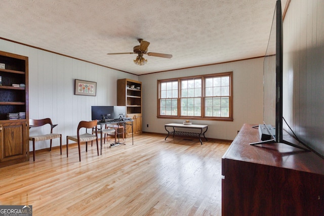 office with ceiling fan, ornamental molding, a textured ceiling, and light wood-type flooring