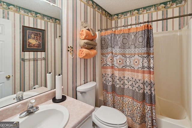 full bathroom with shower / bath combo, vanity, a textured ceiling, and toilet