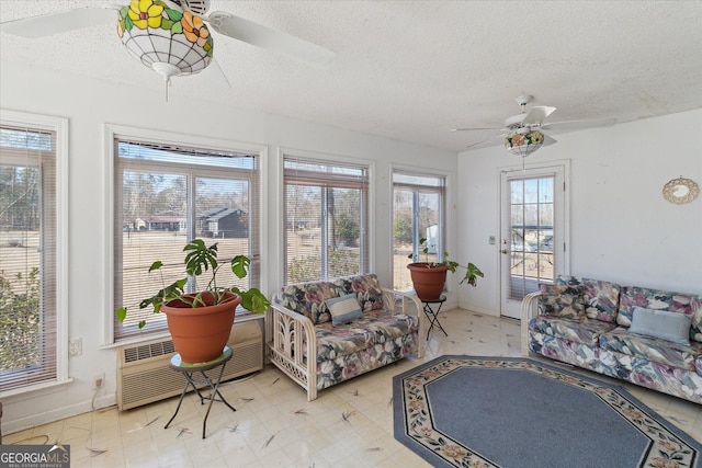 sunroom featuring ceiling fan