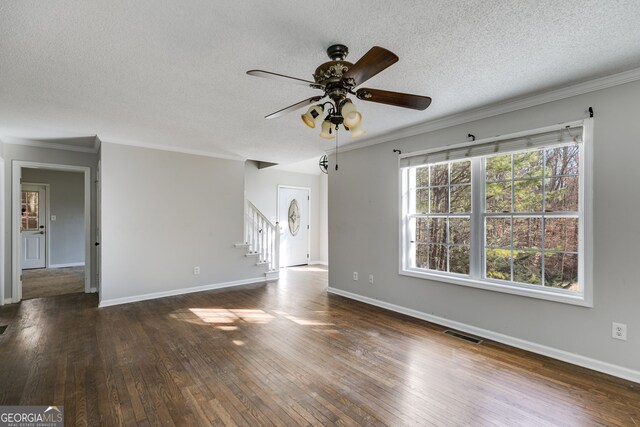 interior space with ornamental molding and a textured ceiling