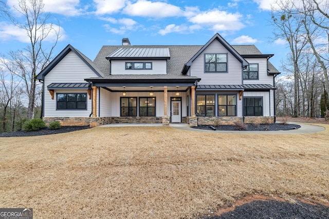 view of front of home with a front yard and a porch