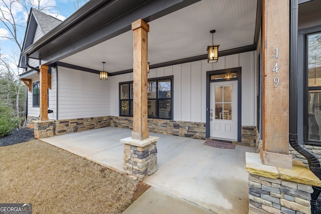 view of exterior entry with covered porch