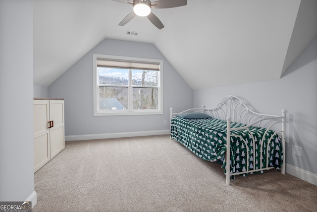 carpeted bedroom with vaulted ceiling and ceiling fan