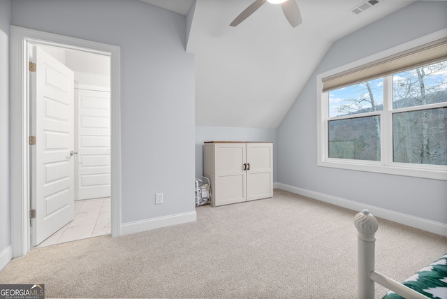 bonus room with ceiling fan, vaulted ceiling, and light carpet