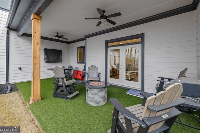 view of patio featuring french doors, ceiling fan, and a fire pit