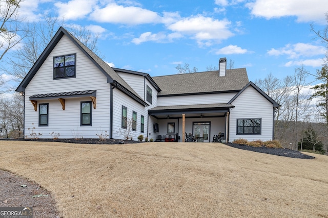 modern farmhouse featuring a front yard and ceiling fan