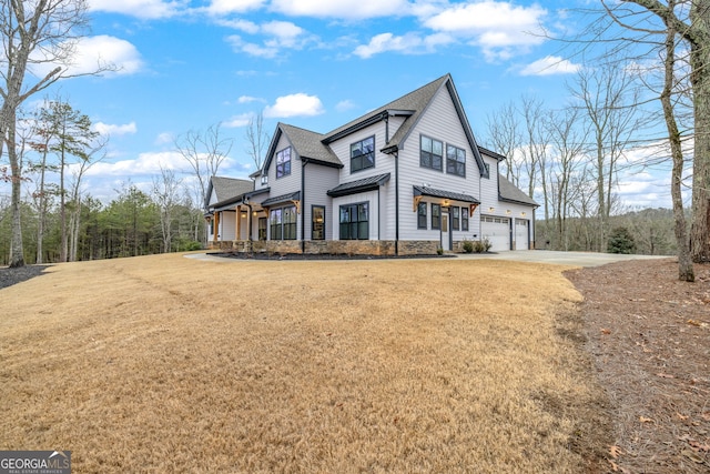 view of front of property with a garage and a front yard