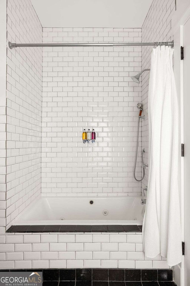 bathroom with shower / bath combo with shower curtain