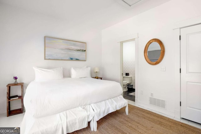 tiled bedroom featuring ensuite bathroom