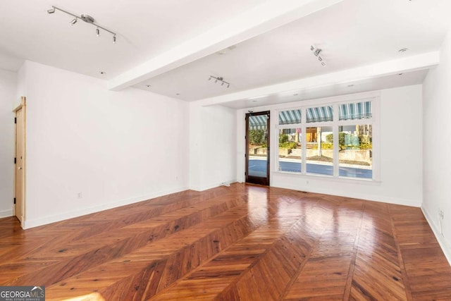 spare room with parquet flooring, track lighting, and beam ceiling