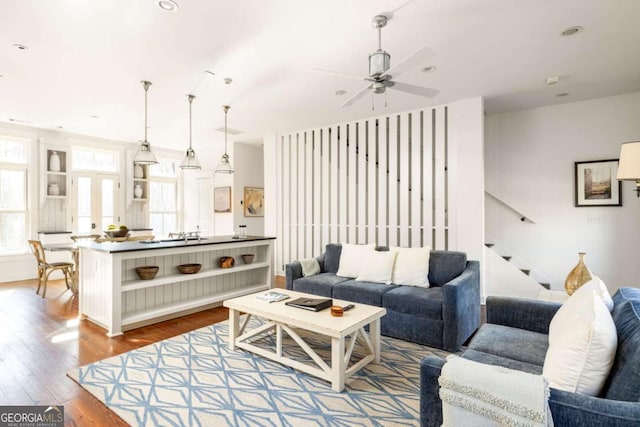 living room featuring hardwood / wood-style flooring and ceiling fan