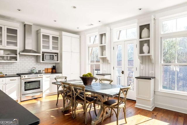 dining room with dark wood-type flooring and french doors