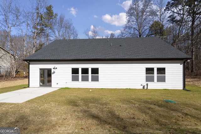 rear view of property with a lawn and a patio