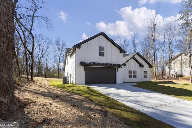 modern inspired farmhouse featuring a garage, central AC unit, and a front lawn