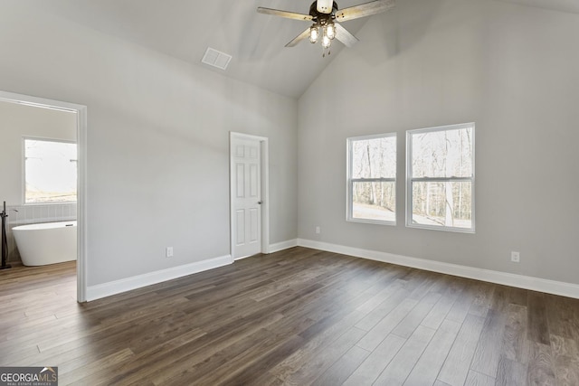 unfurnished room featuring ceiling fan, dark hardwood / wood-style flooring, and a wealth of natural light