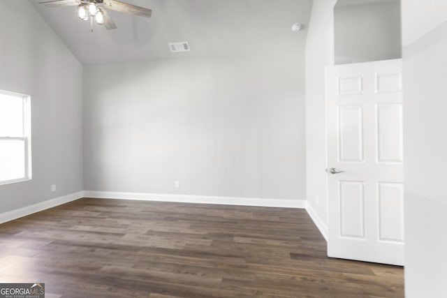 spare room featuring lofted ceiling, dark wood-type flooring, and ceiling fan