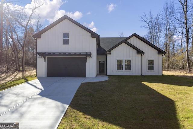 modern farmhouse featuring a garage and a front lawn