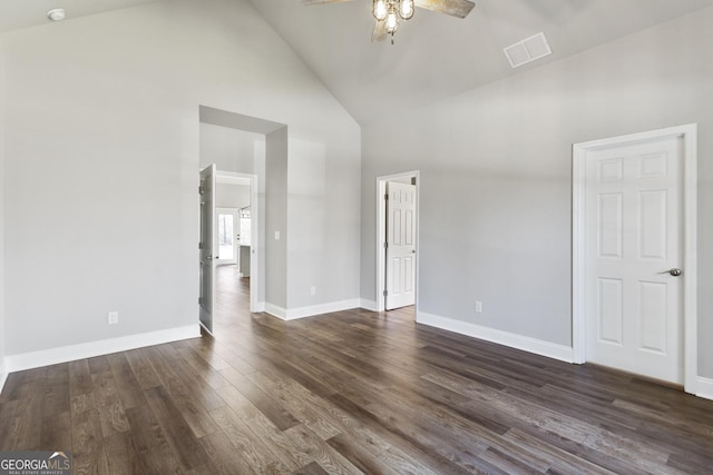 unfurnished room featuring dark wood-type flooring, high vaulted ceiling, and ceiling fan