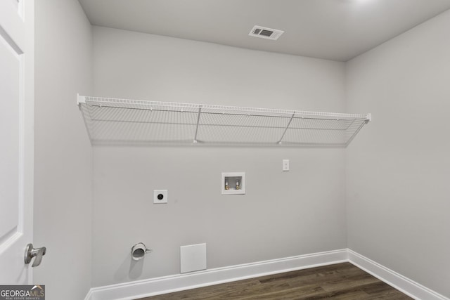 clothes washing area featuring hookup for a washing machine, electric dryer hookup, and dark wood-type flooring