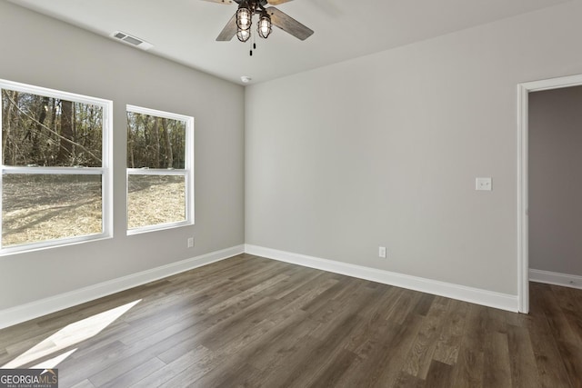 spare room featuring ceiling fan and dark hardwood / wood-style floors