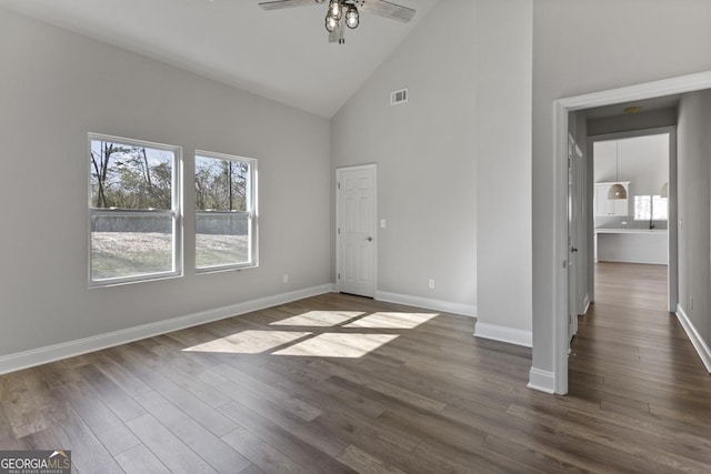 unfurnished bedroom featuring dark hardwood / wood-style floors and high vaulted ceiling