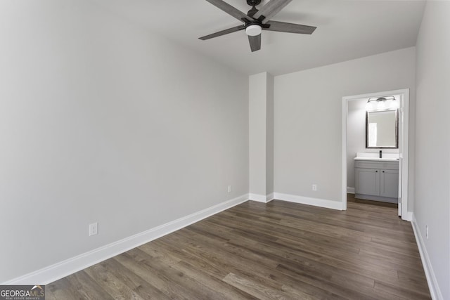 unfurnished bedroom featuring ceiling fan, connected bathroom, and dark hardwood / wood-style flooring