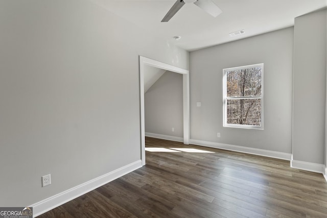 empty room featuring ceiling fan and dark hardwood / wood-style flooring