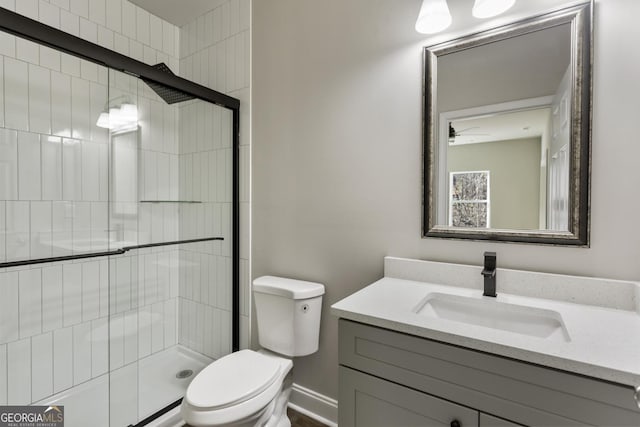 bathroom featuring walk in shower, vanity, and toilet