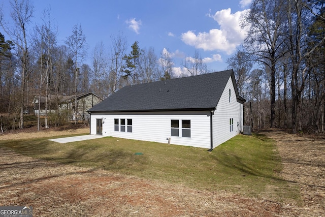 exterior space with cooling unit, a yard, and a patio area