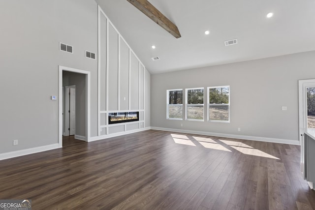 unfurnished living room featuring dark hardwood / wood-style floors, high vaulted ceiling, a large fireplace, and beam ceiling