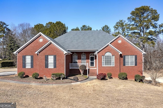 ranch-style house featuring a porch and a front lawn