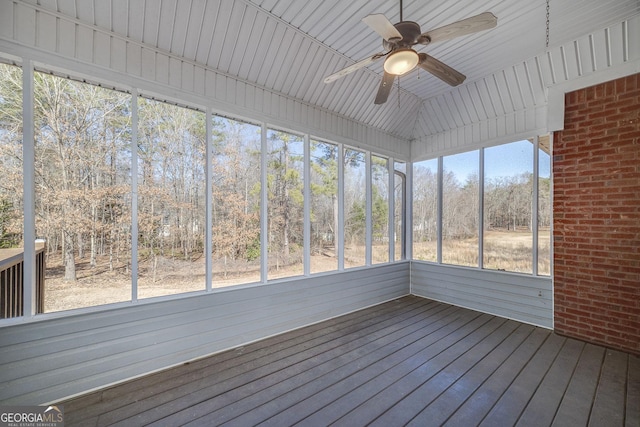 unfurnished sunroom with a ceiling fan