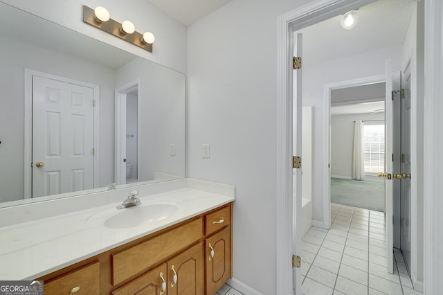 full bathroom featuring tile patterned floors, toilet, vanity, and baseboards