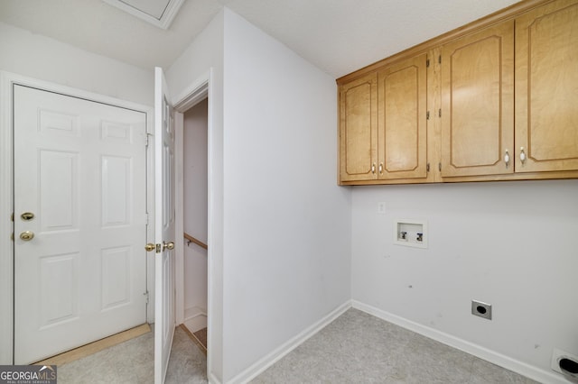clothes washing area with electric dryer hookup, washer hookup, cabinet space, and baseboards