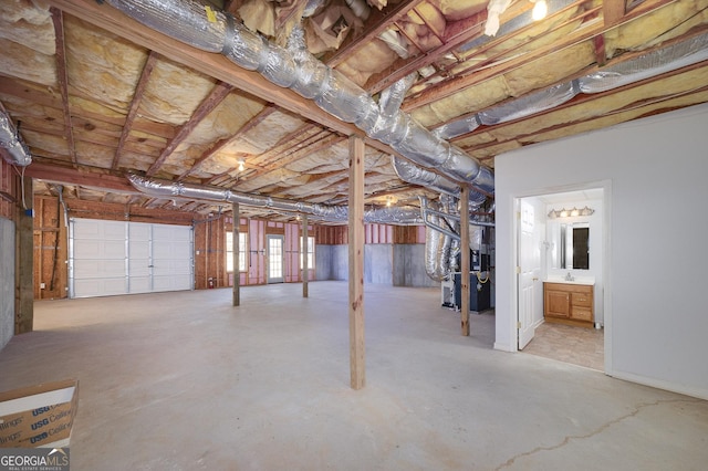 basement with heating unit and a sink