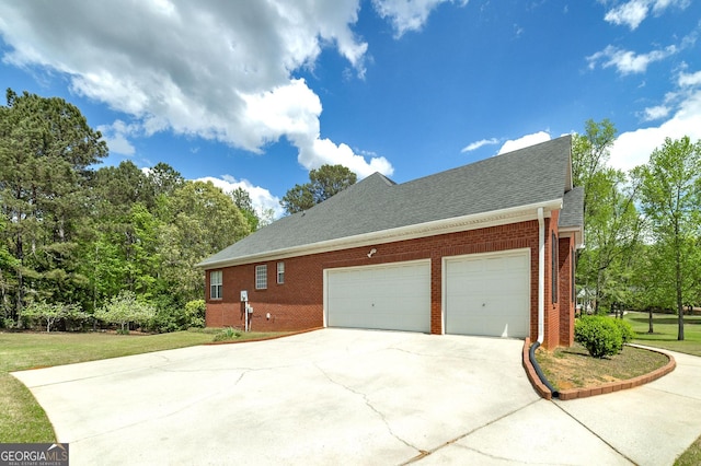 view of home's exterior with a yard, brick siding, driveway, roof with shingles, and an attached garage