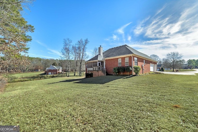 view of home's exterior with concrete driveway, a chimney, a lawn, brick siding, and a garage