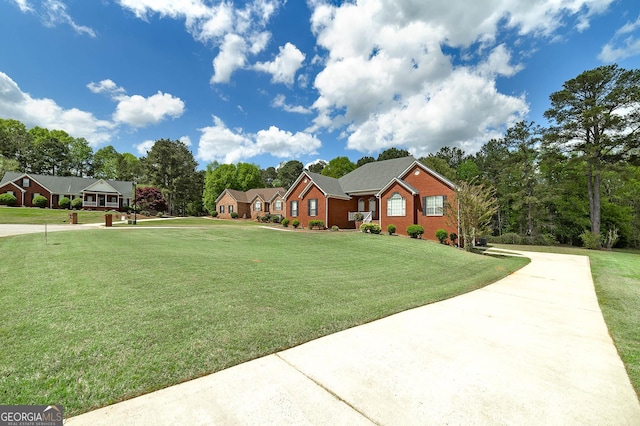 view of front facade featuring a front lawn and concrete driveway