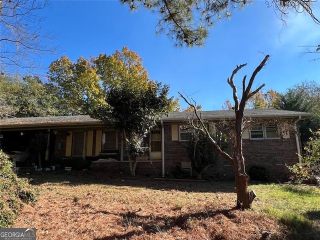 rear view of house featuring a yard