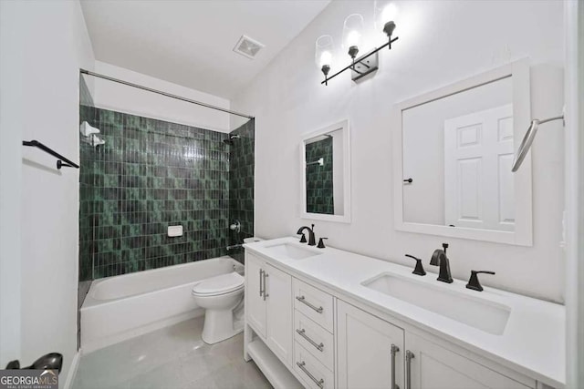 full bathroom with tiled shower / bath combo, vanity, and toilet