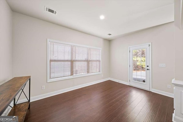 unfurnished room featuring dark hardwood / wood-style floors