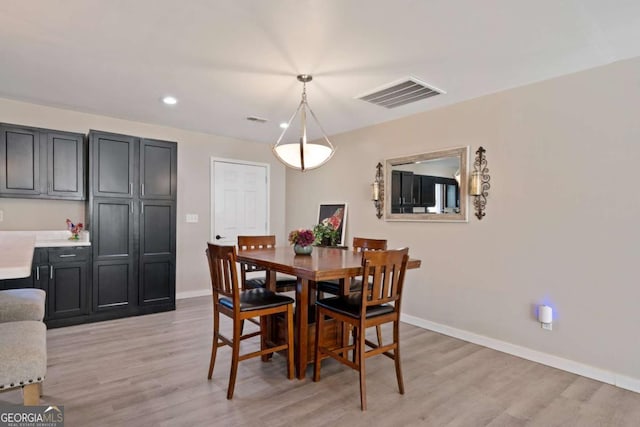 dining area featuring light wood-type flooring