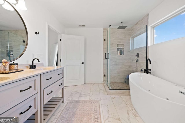 bathroom with vanity and separate shower and tub